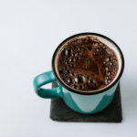 Coffee mug on a bespoke melamine coasters and white background.