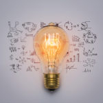 Light bulb and drawings around it about promotional marketing ideas.